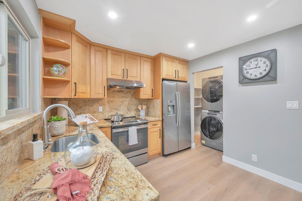 1181 Oddstad Boulevard Pacifica, CA 94044 - Photo 11 of 35 a kitchen with refrigerator a stove a washer and dryer
