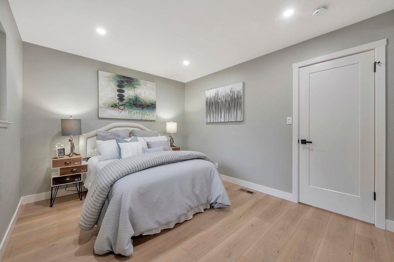 1181 Oddstad Boulevard Pacifica, CA 94044 - Photo 16 of 35 a bedroom with a bed and painting on the wall