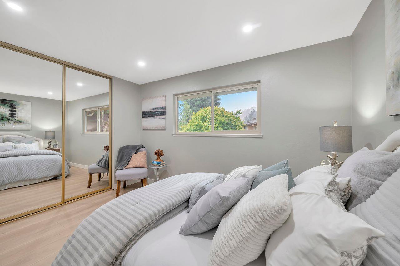 1181 Oddstad Boulevard Pacifica, CA 94044 - Photo 18 of 35 a bedroom with a bed and wooden floor