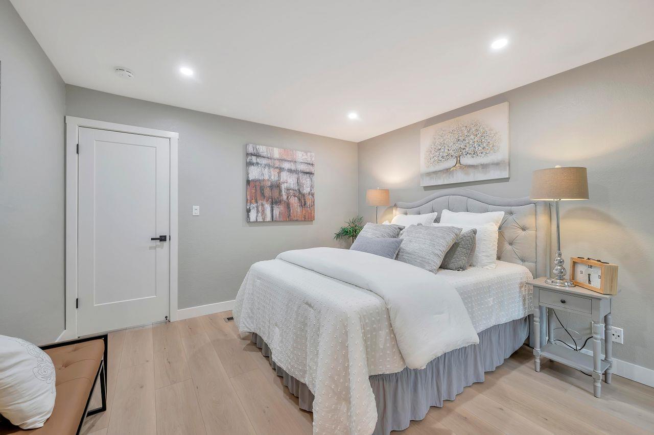 1181 Oddstad Boulevard Pacifica, CA 94044 - Photo 20 of 35 a bedroom with a bed and a night stand