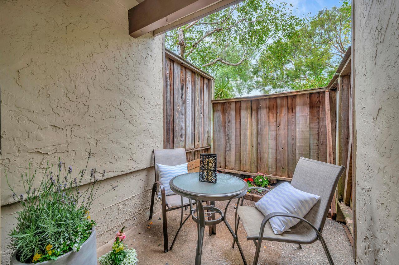 1181 Oddstad Boulevard Pacifica, CA 94044 - Photo 30 of 35 a backyard with table and chairs with an umbrella