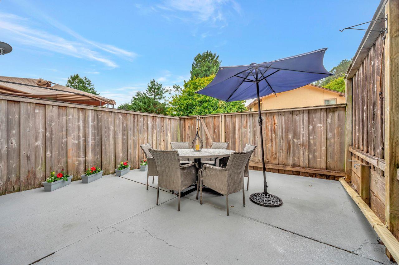 1181 Oddstad Boulevard Pacifica, CA 94044 - Photo 31 of 35 a view of patio with a table and chairs under an umbrella