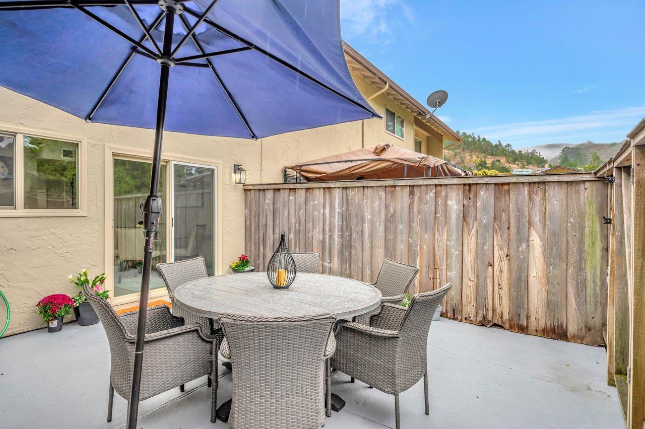 1181 Oddstad Boulevard Pacifica, CA 94044 - Photo 33 of 35 a table and chairs under an umbrella