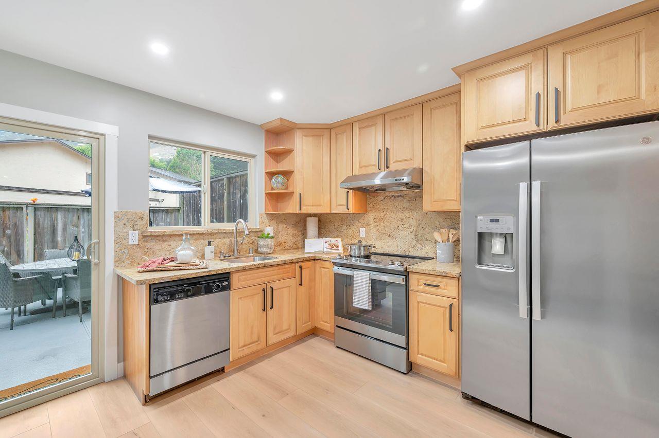 1181 Oddstad Boulevard Pacifica, CA 94044 - Photo 10 of 35 a kitchen with stainless steel appliances granite countertop a stove a refrigerator and a refrigerator