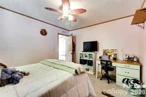 179 Fresh Water Rdg Road Whittier, NC 28789 - Photo 29 of 48 a bedroom with a bed and flat screen tv