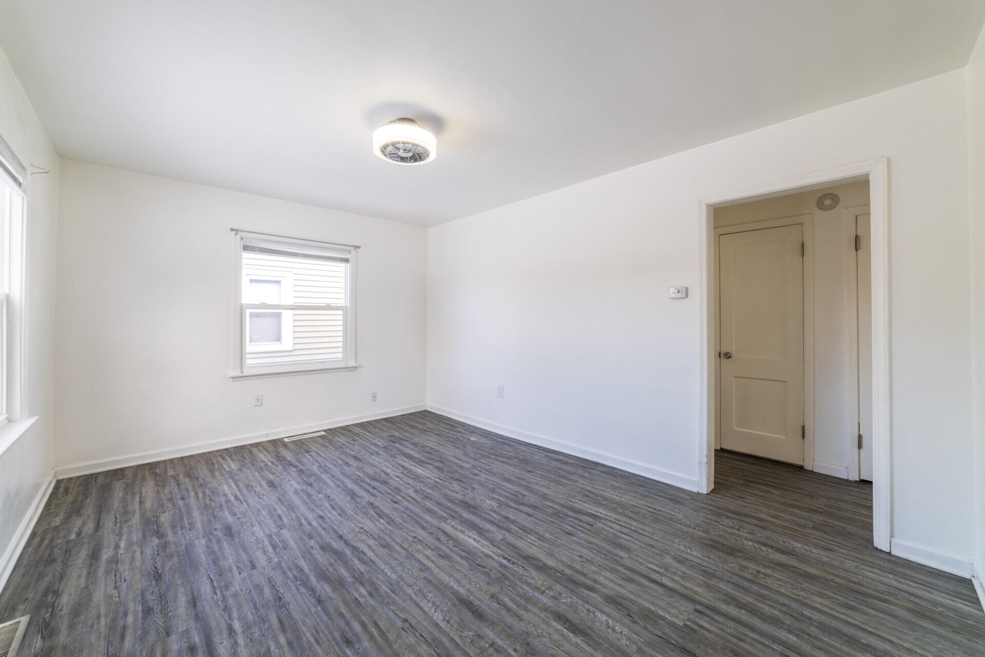 2267 Tennessee Street Gary, IN 46407 - Photo 15 of 22 an empty room with wooden floor and windows