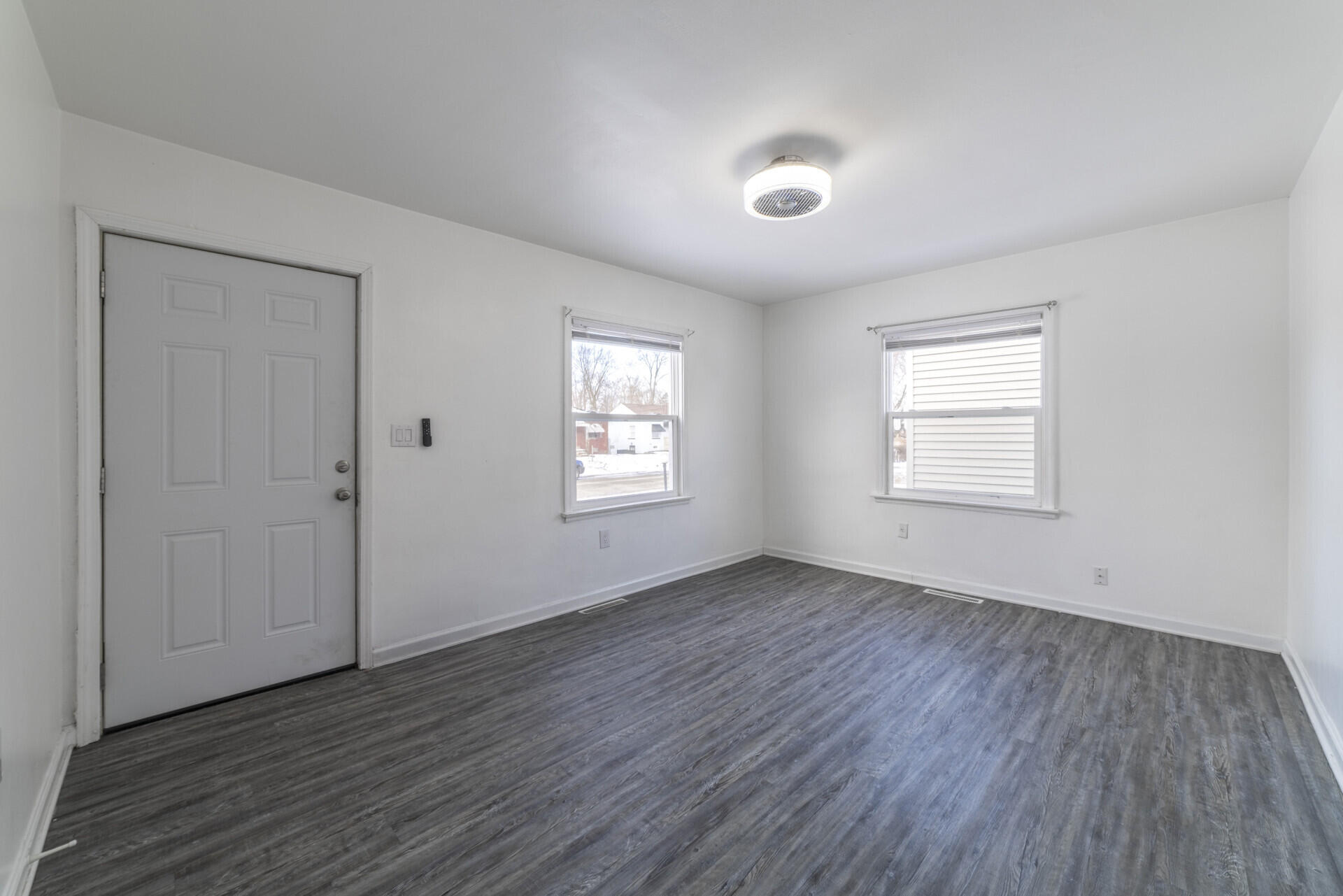 2267 Tennessee Street Gary, IN 46407 - Photo 16 of 22 an empty room with wooden floor and windows