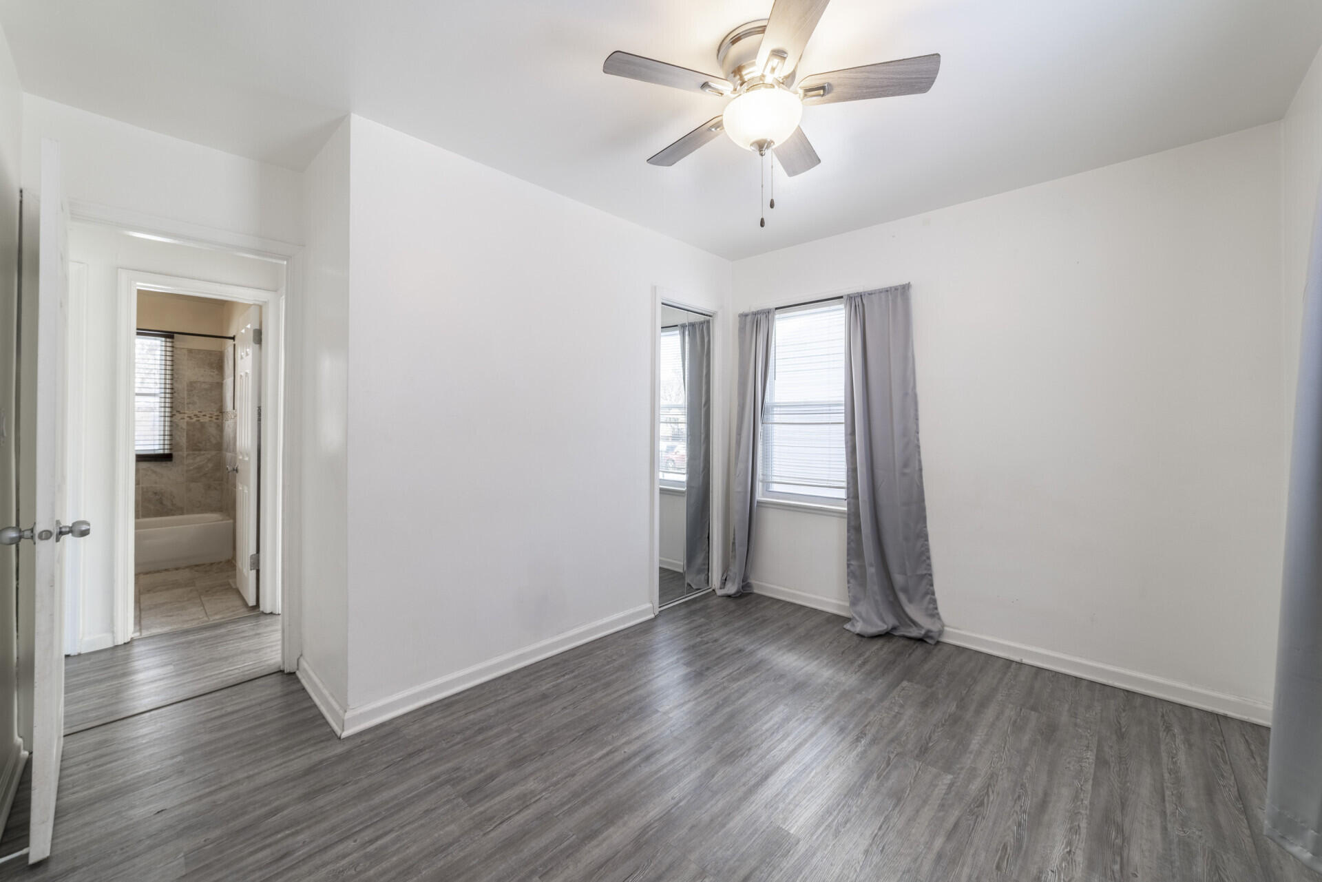2267 Tennessee Street Gary, IN 46407 - Photo 18 of 22 an empty room with wooden floor and a ceiling fan