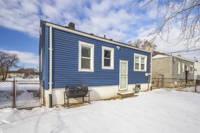 a backyard of a house with yard and outdoor seating