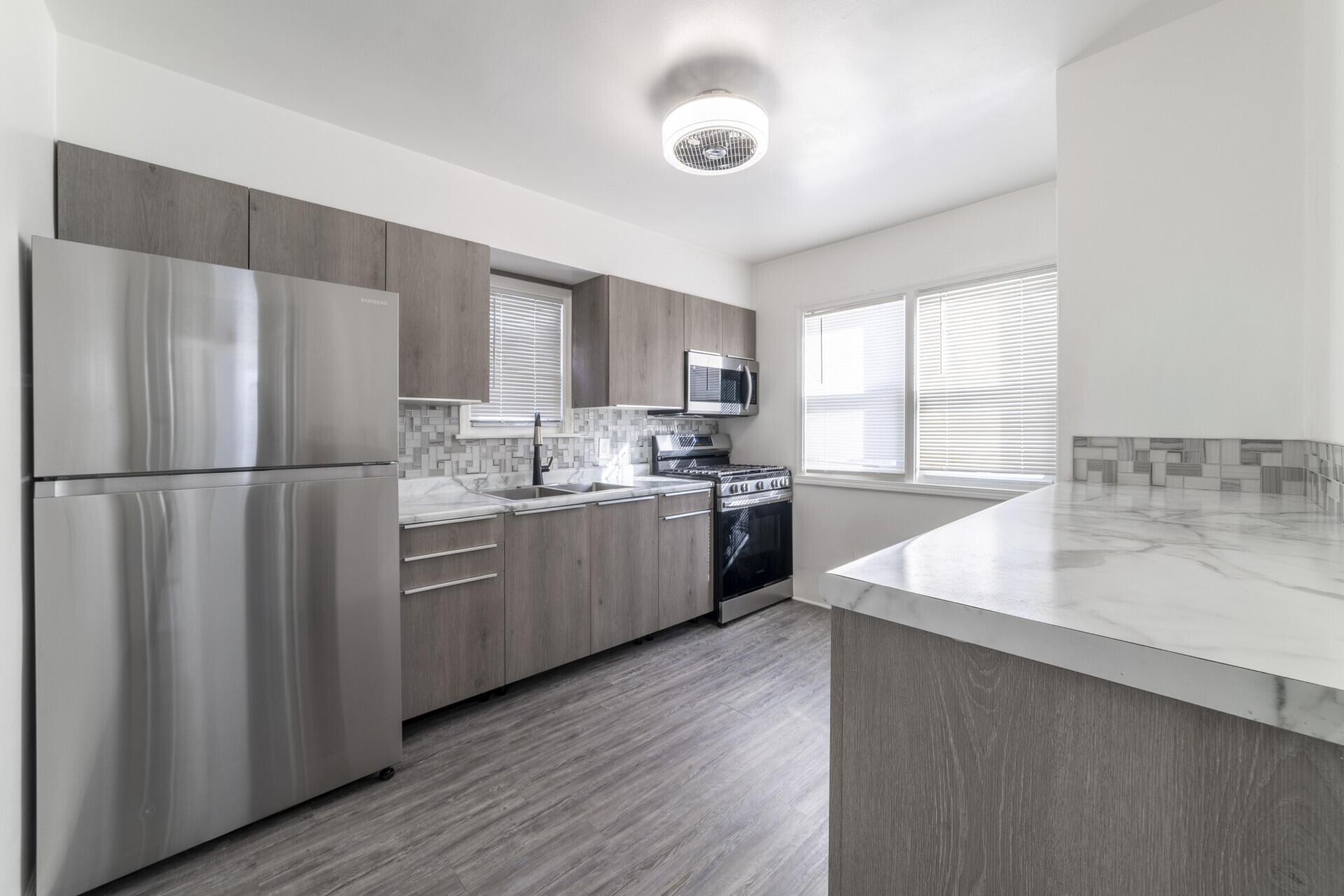 2267 Tennessee Street Gary, IN 46407 - Photo 7 of 22 a kitchen with a refrigerator a sink and cabinets