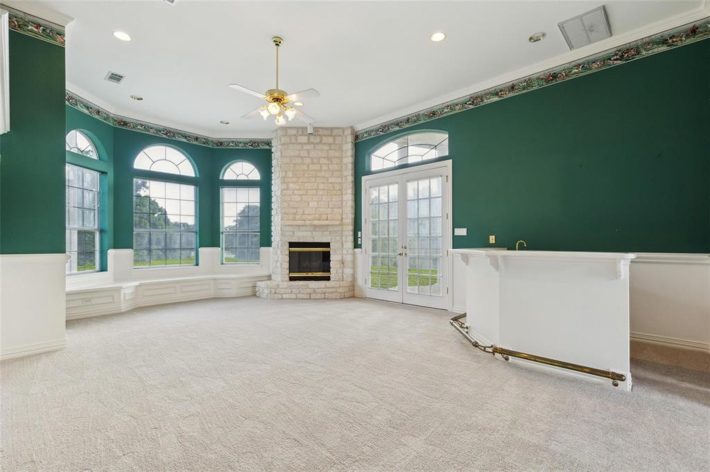800 John McCain Road Colleyville, TX 76034 - Photo 23 of 38 a view of an empty room with a fireplace and a window