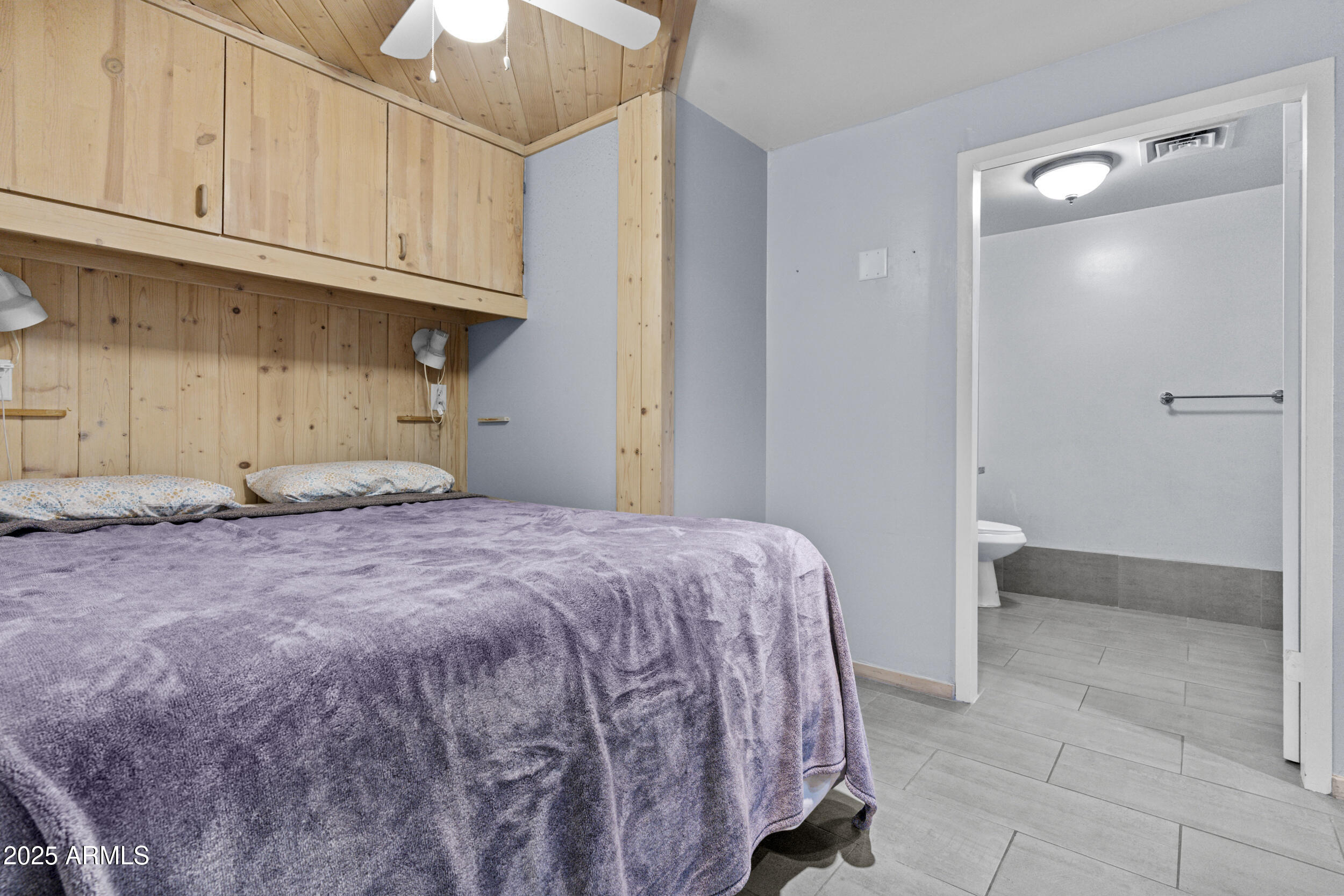 6125 East Indian School Road, Unit 247 Scottsdale, AZ 85251 - Photo 11 of 13 a bedroom with a bed and cabinets