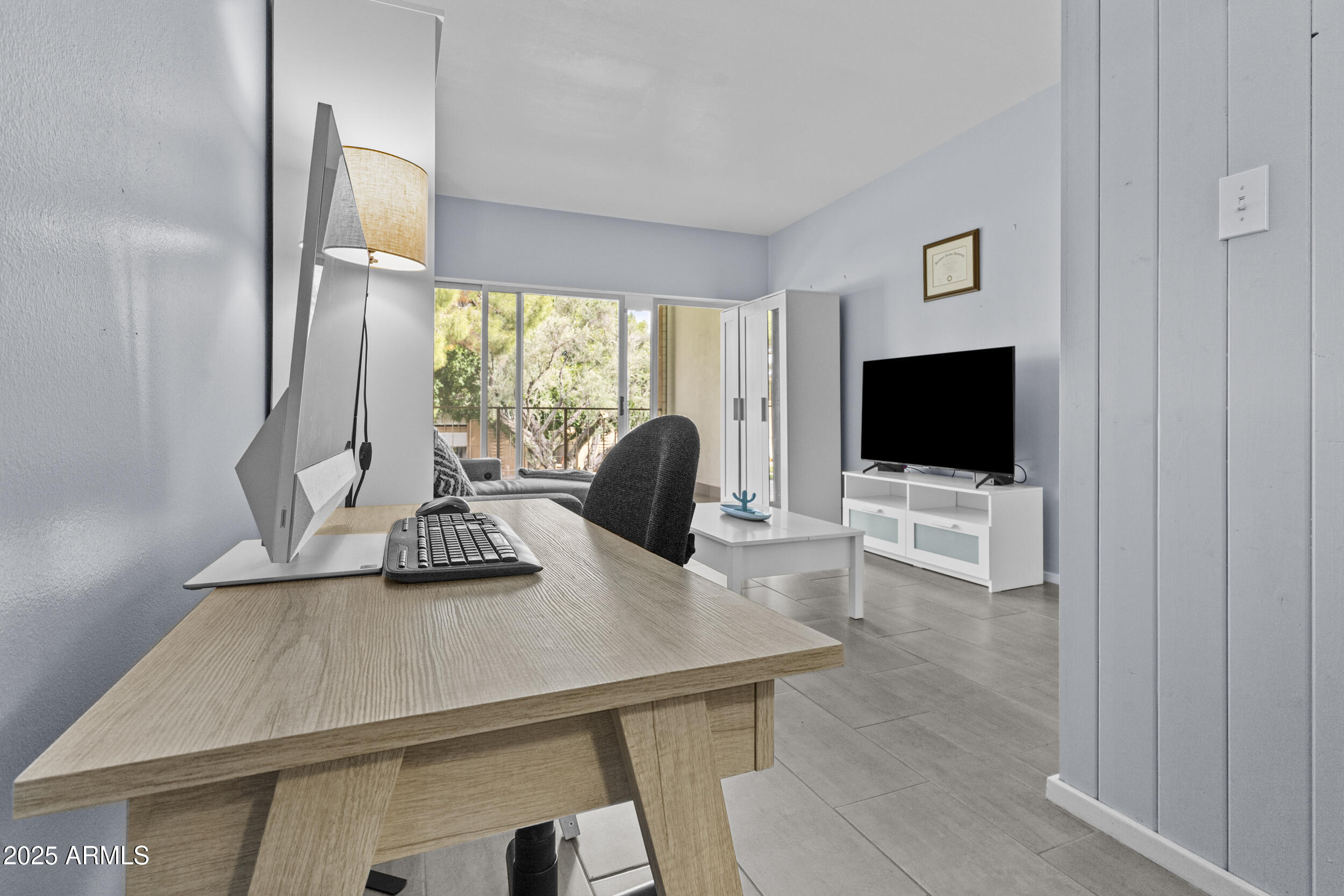 6125 East Indian School Road, Unit 247 Scottsdale, AZ 85251 - Photo 4 of 13 a living room with furniture and a flat screen tv