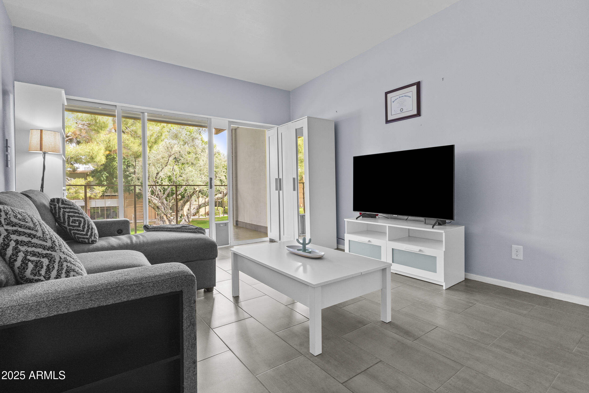 6125 East Indian School Road, Unit 247 Scottsdale, AZ 85251 - Photo 5 of 13 a living room with furniture and a flat screen tv