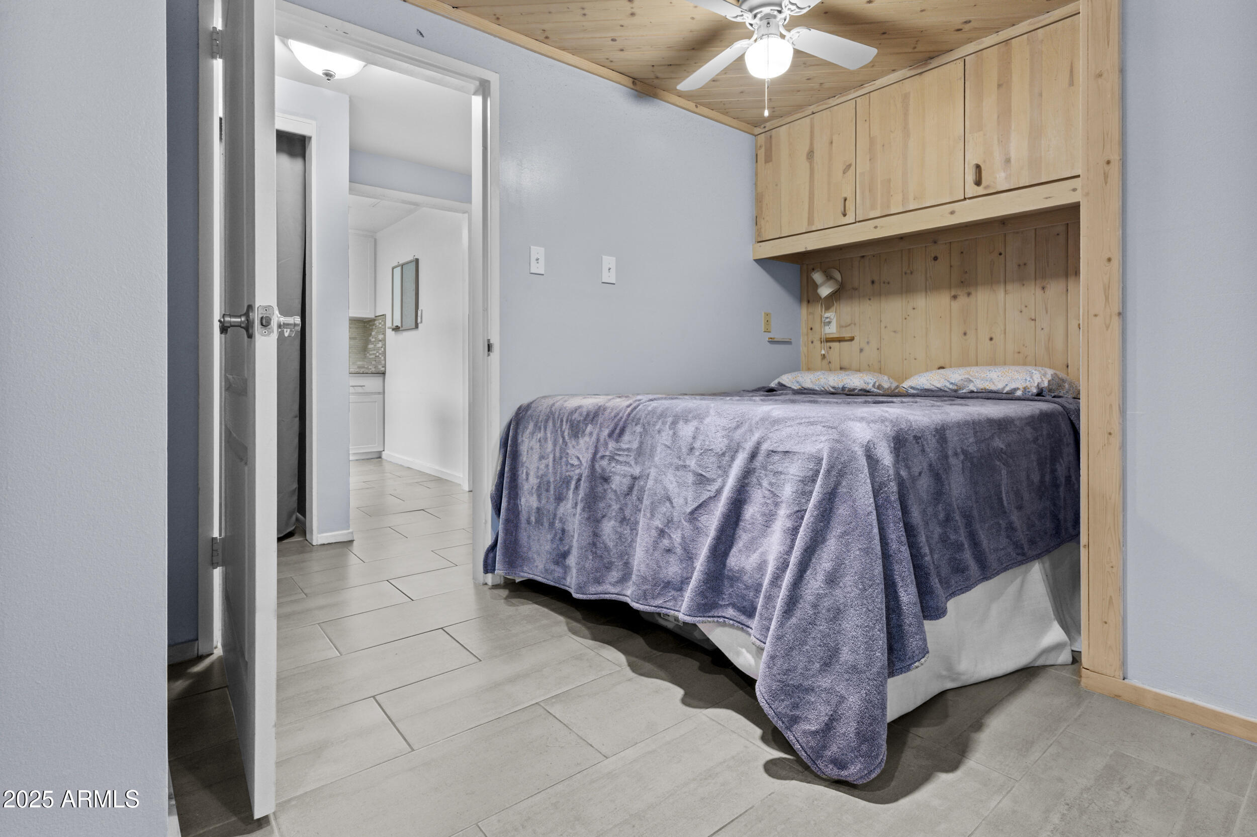 6125 East Indian School Road, Unit 247 Scottsdale, AZ 85251 - Photo 10 of 13 a room with a bed and a ceiling fan