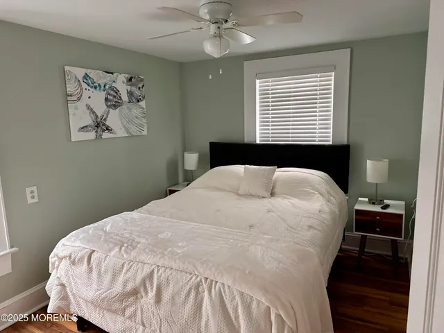 a large bed sitting in a bedroom next to a window