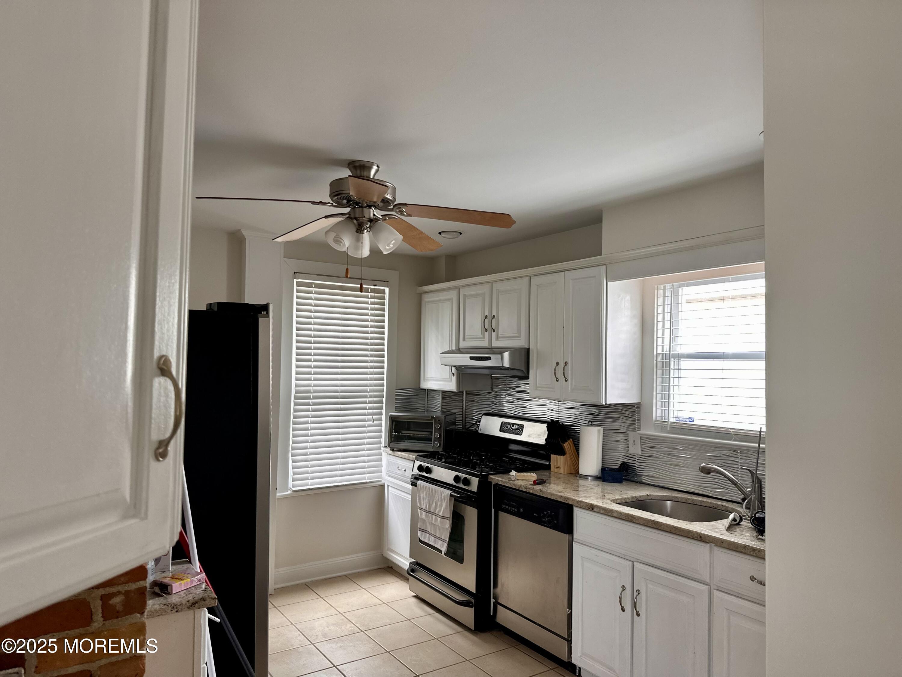 612 Sylvania Avenue Avon-by-the-Sea, NJ 07717 - Photo 13 of 17 a kitchen with a sink appliances cabinets and a window