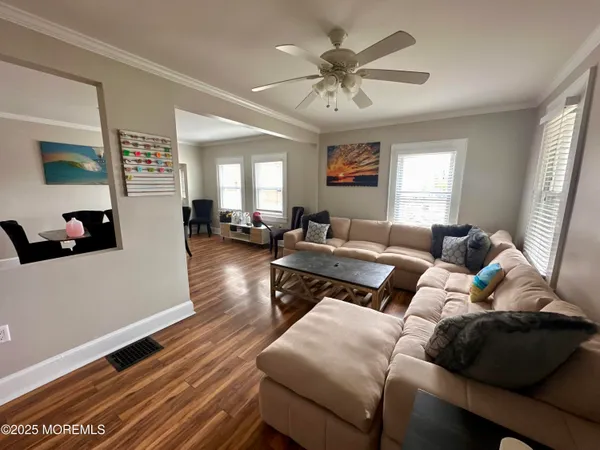 a living room with furniture and wooden floor