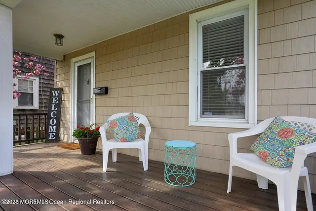 a porch with furniture and a potted plant