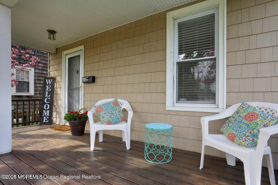 612 Sylvania Avenue Avon-by-the-Sea, NJ 07717 - Photo 5 of 17 a porch with furniture and a potted plant