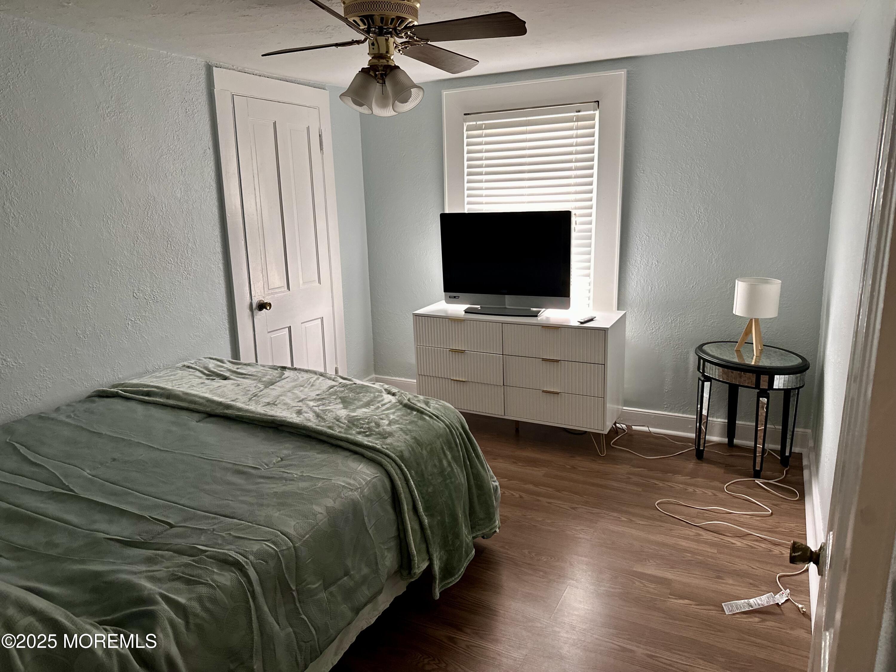 612 Sylvania Avenue Avon-by-the-Sea, NJ 07717 - Photo 10 of 17 a bedroom with a bed and a flat screen tv