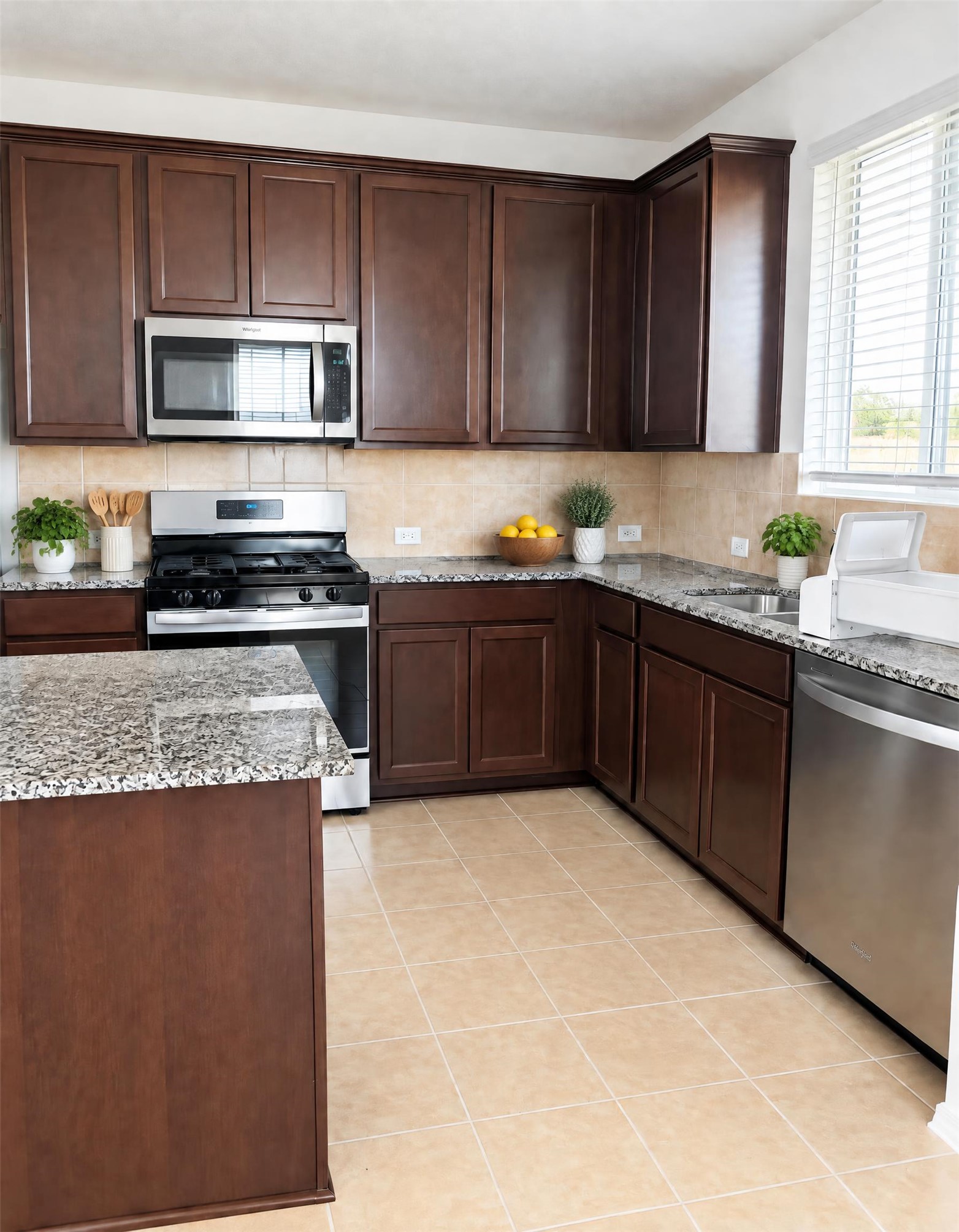 545 Henry Milton Road Georgetown, TX 78626 - Photo 28 of 33 Rich wood cabinetry paired with granite countertops defines this well-appointed kitchen.