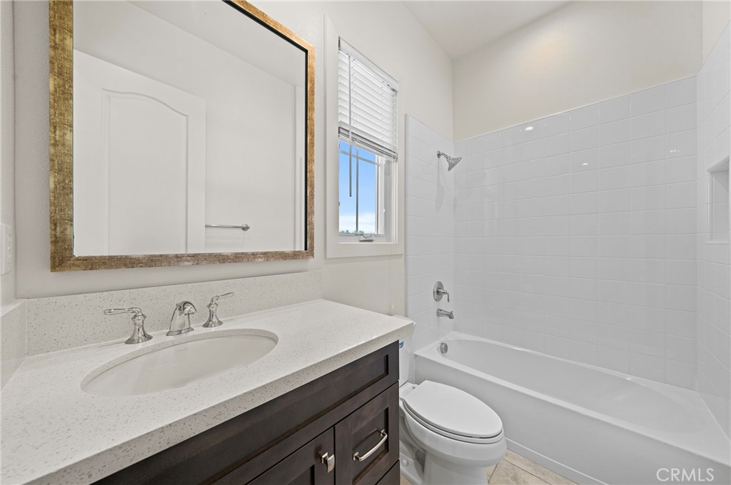 52 Eider Run Irvine, CA 92618 - Photo 14 of 46 a bathroom with a granite countertop sink toilet and shower