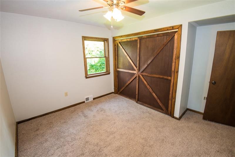 85 McClure Road Cheswick, PA 15024 - Photo 11 of 25 Second bedroom featuring a large closet with barn doors.
