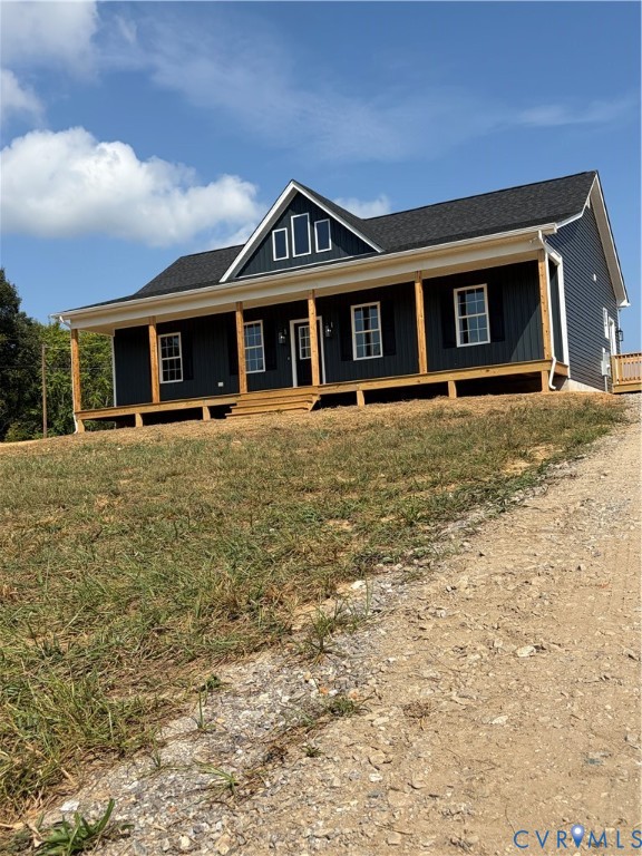 Dark-toned siding with white trim, a covered front