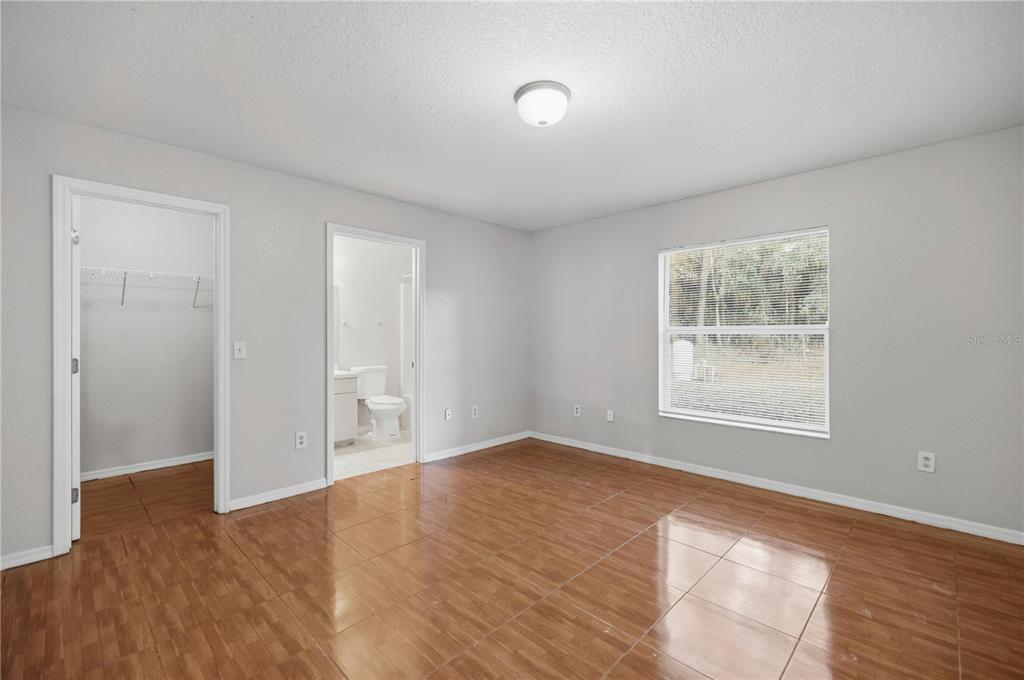 14 Cedar Tree Terrace Ocala, FL 34472 - Photo 17 of 32 an empty room with wooden floor and windows
