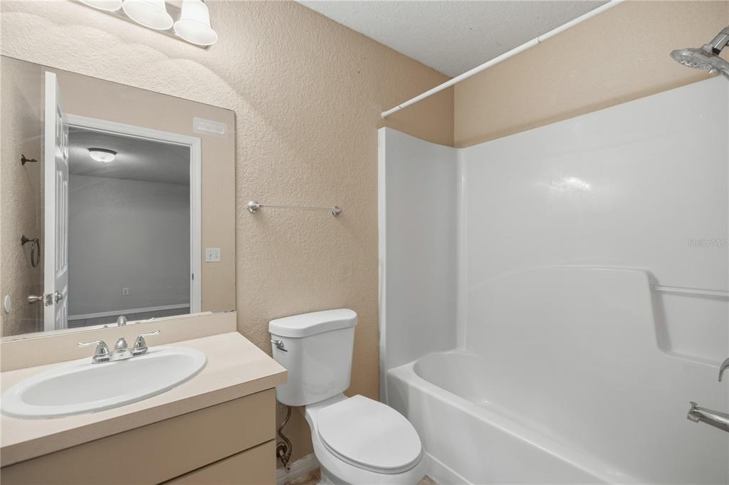 14 Cedar Tree Terrace Ocala, FL 34472 - Photo 19 of 32 a white toilet and tub sitting next to a bathroom sink