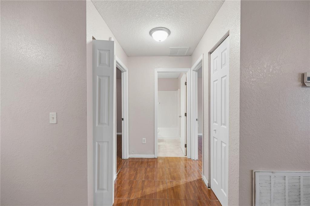 14 Cedar Tree Terrace Ocala, FL 34472 - Photo 20 of 32 a view of a hallway with wooden floor and a bathroom