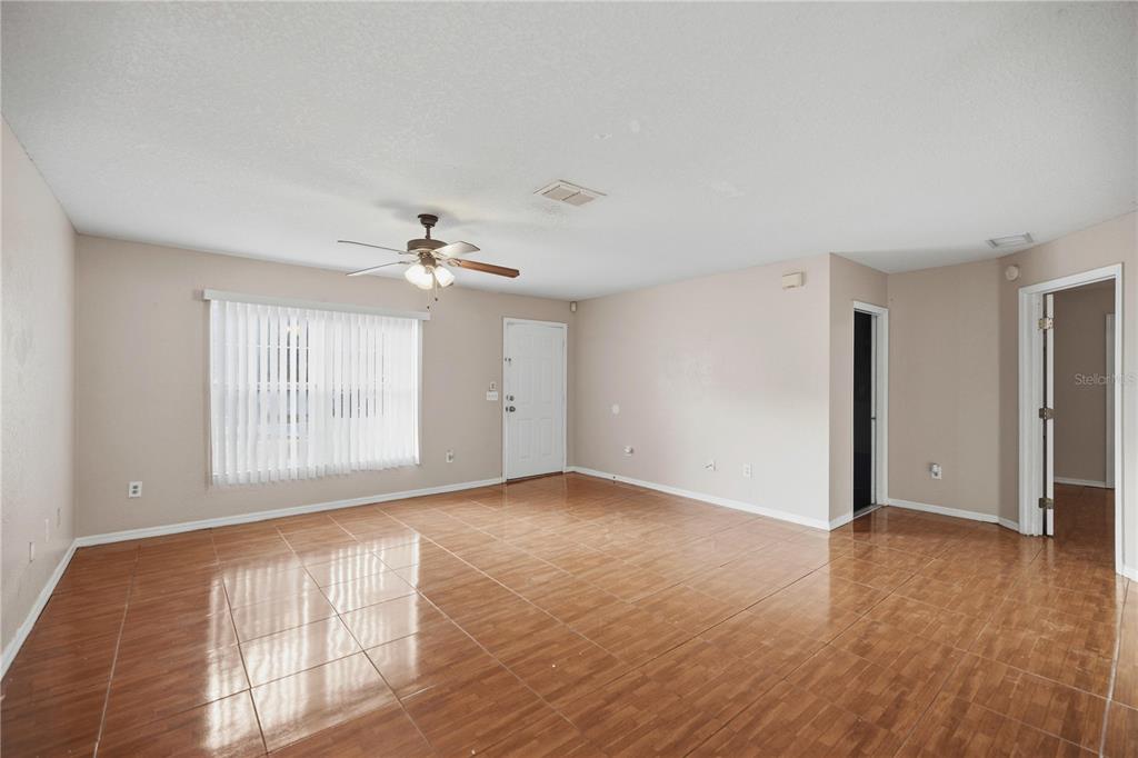 14 Cedar Tree Terrace Ocala, FL 34472 - Photo 10 of 32 a view of an empty room with wooden floor and a window