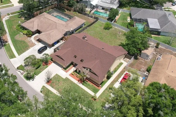 an aerial view of a house with a yard
