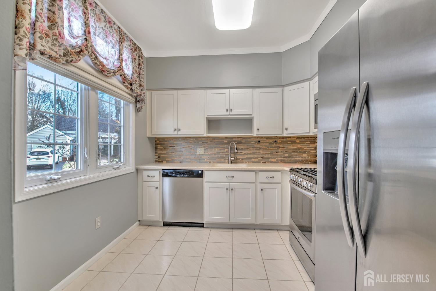 30 Winthrop Road Monroe Township, NJ 08831 - Photo 15 of 42 a kitchen with a refrigerator a sink and cabinets