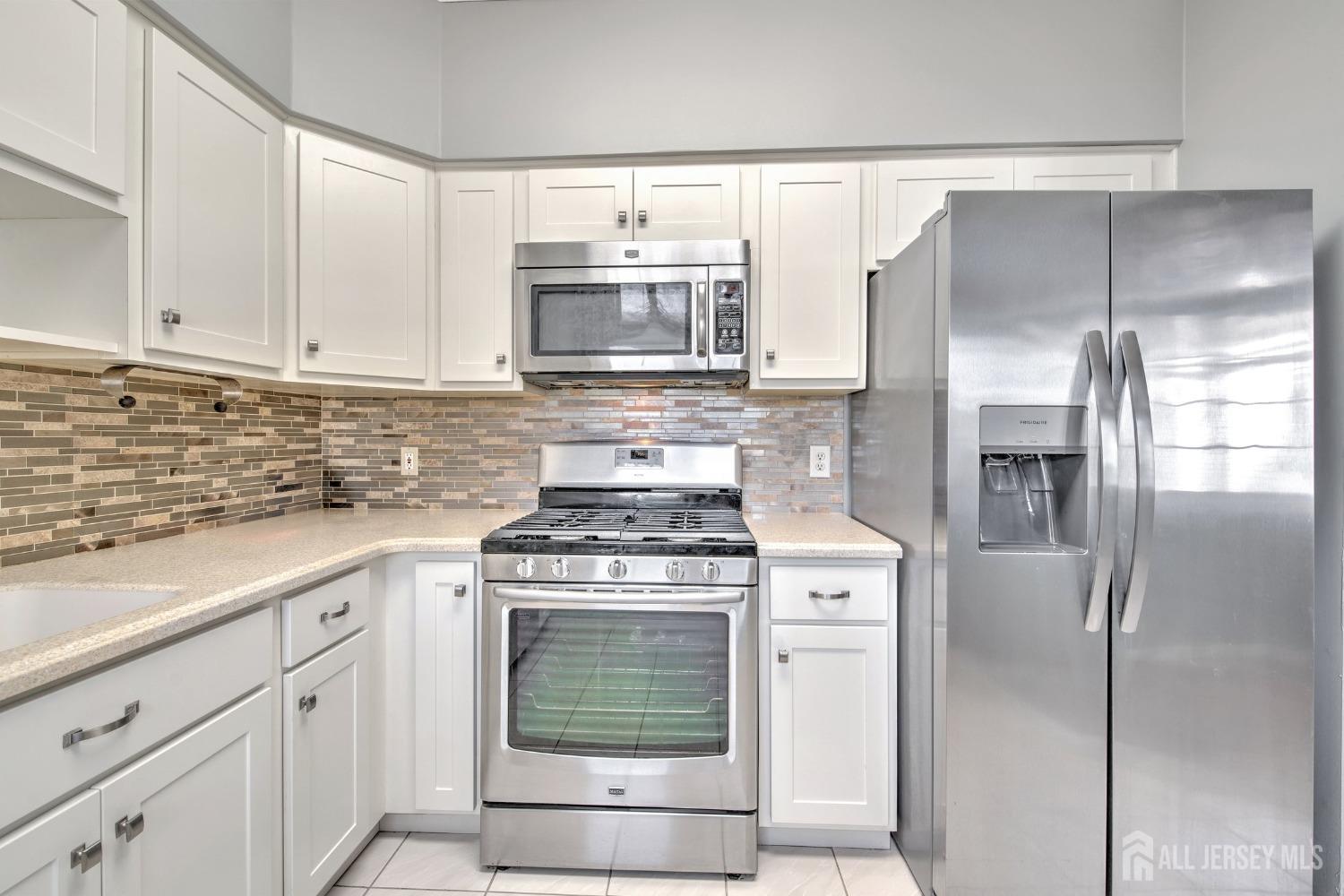 30 Winthrop Road Monroe Township, NJ 08831 - Photo 16 of 42 a kitchen with stainless steel appliances granite countertop a stove a refrigerator and a white cabinets