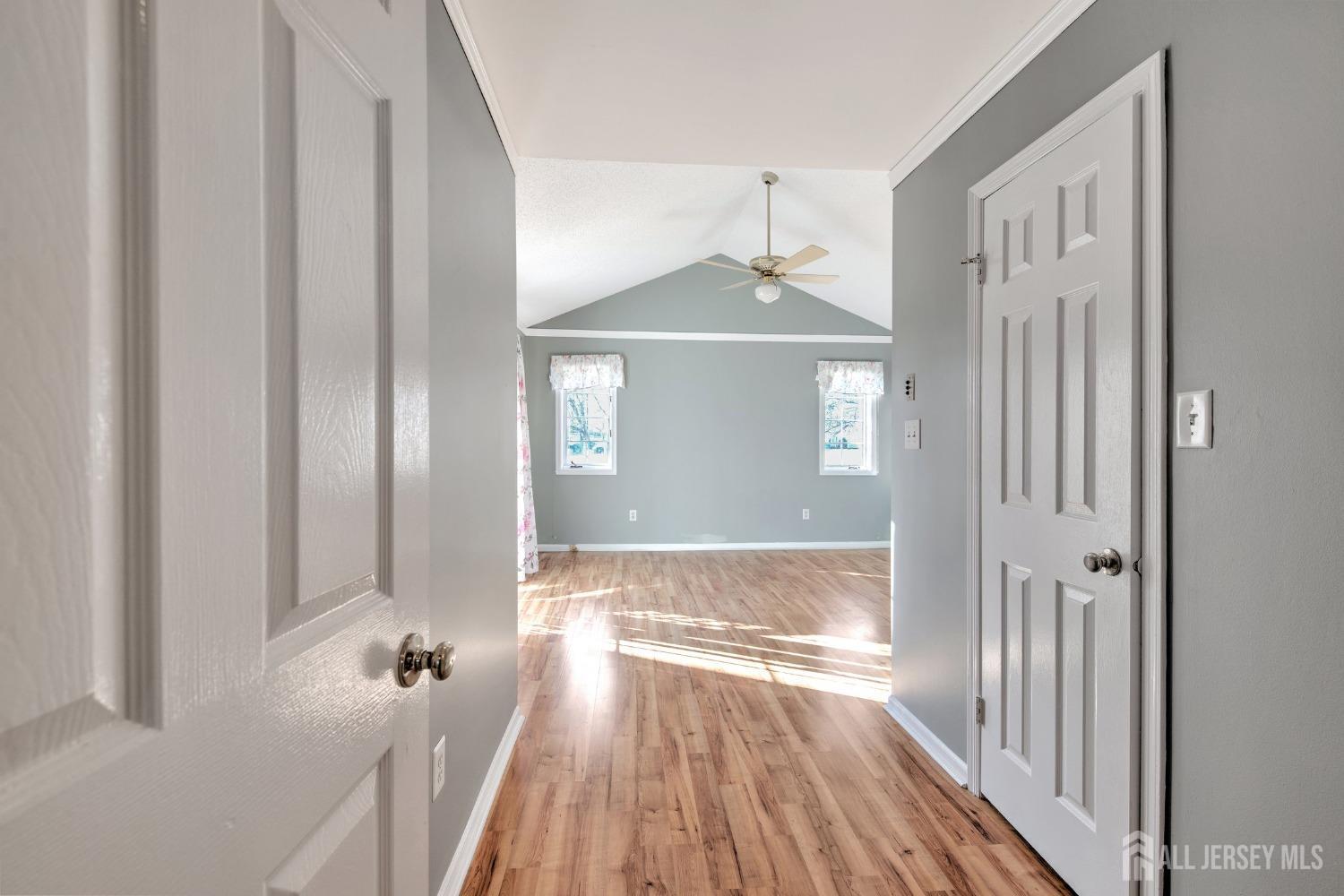 30 Winthrop Road Monroe Township, NJ 08831 - Photo 18 of 42 a view of a hallway with wooden floor and a living room