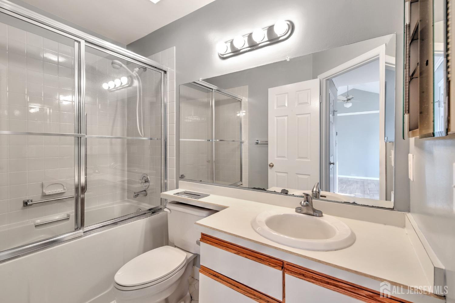 30 Winthrop Road Monroe Township, NJ 08831 - Photo 23 of 42 a bathroom with a sink a toilet and a large mirror