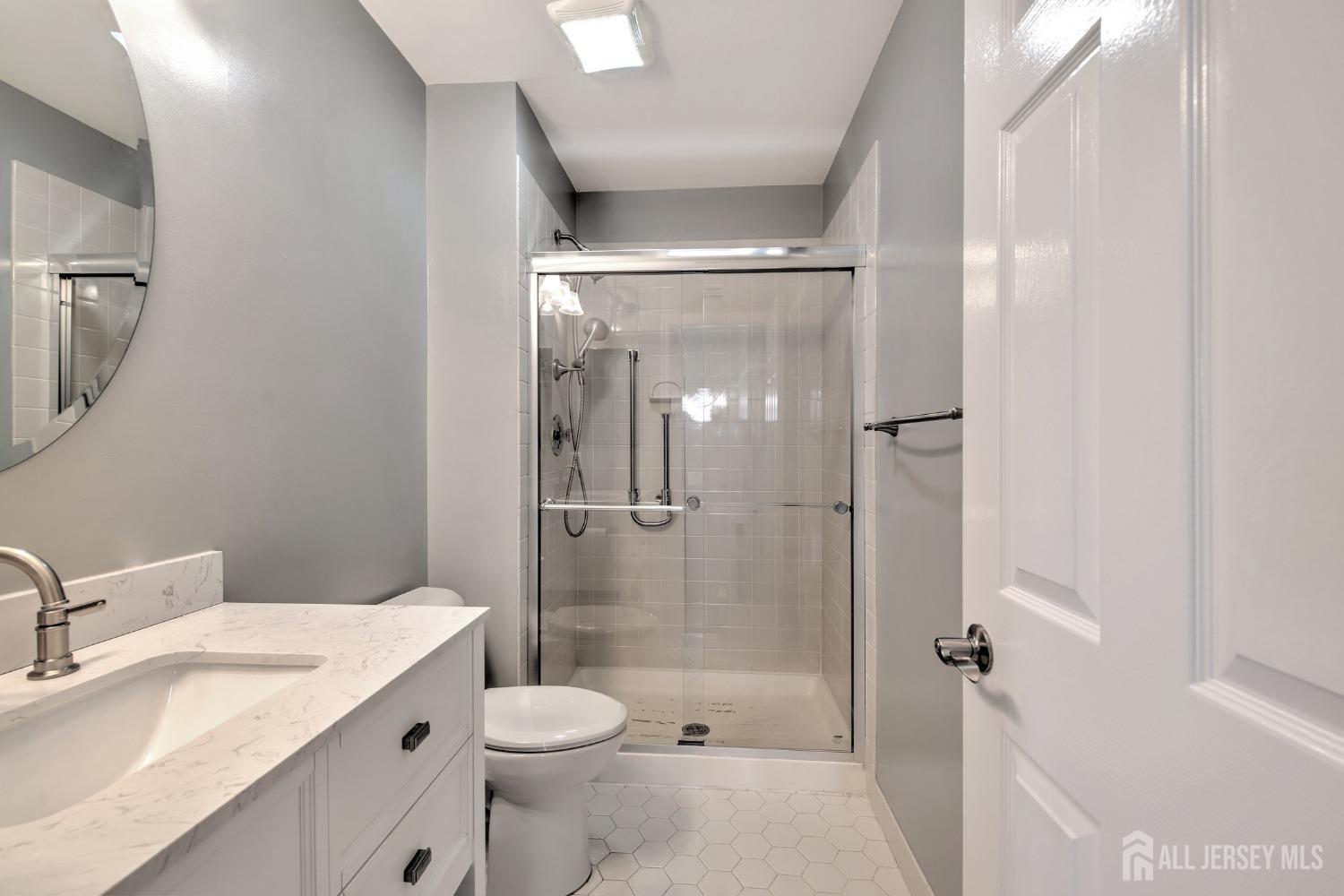 30 Winthrop Road Monroe Township, NJ 08831 - Photo 27 of 42 a bathroom with a granite countertop sink toilet and shower