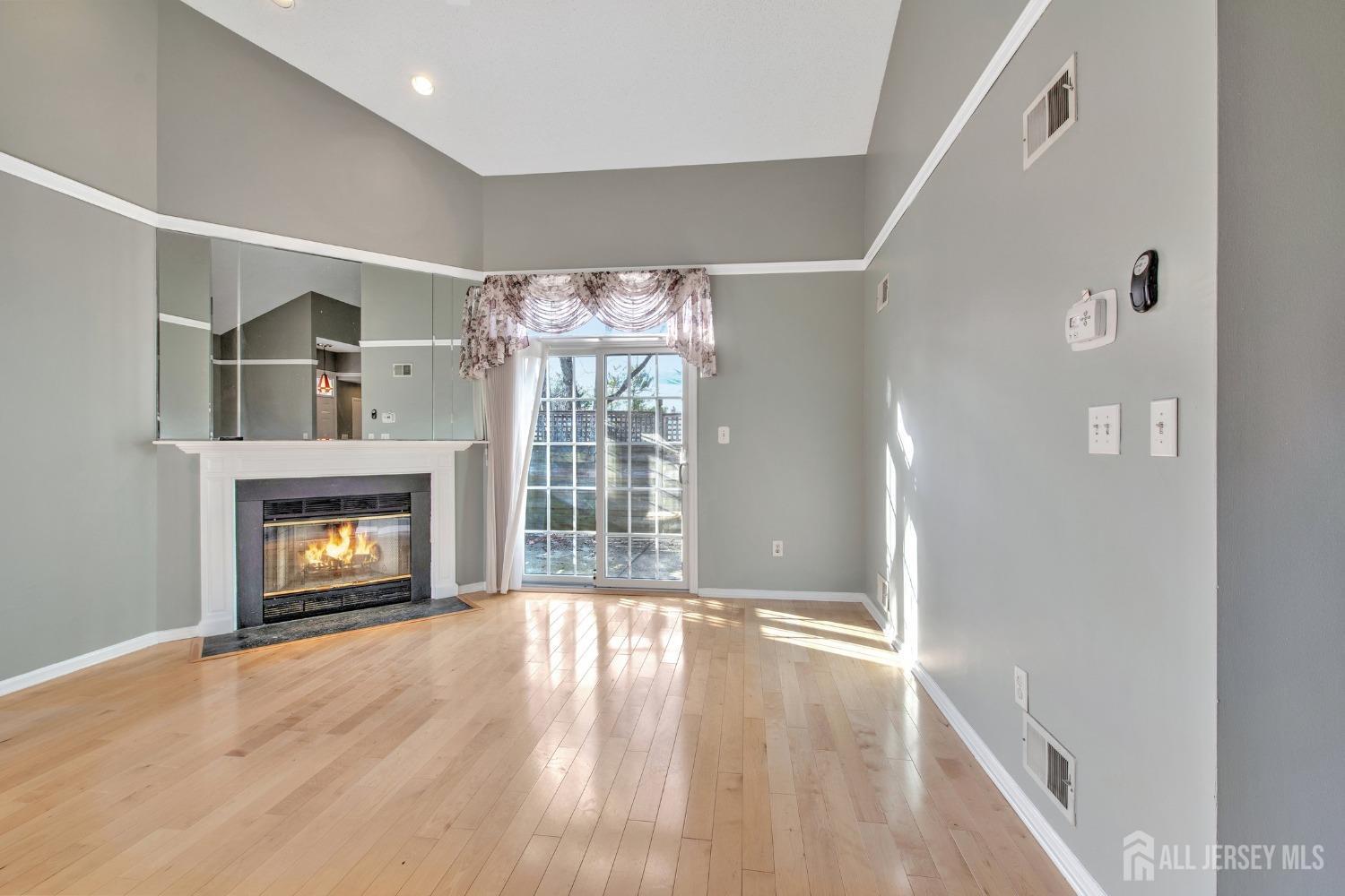 30 Winthrop Road Monroe Township, NJ 08831 - Photo 7 of 42 a view of an empty room with wooden floor fireplace and a window