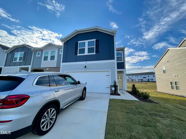 a view of a car parked in front of a house