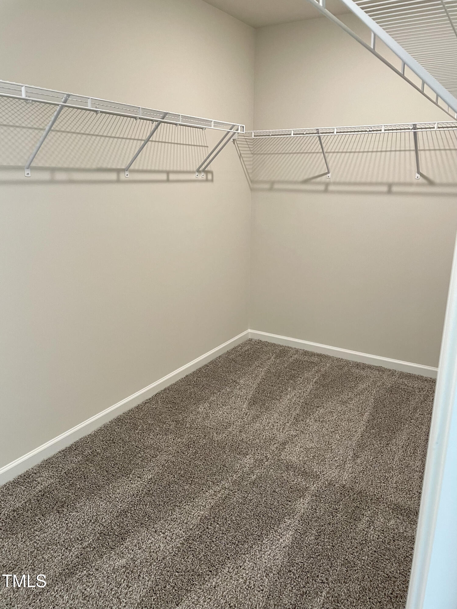 912 Field Ivy Drive Fuquay-Varina, NC 27526 - Photo 14 of 27 a view of a room with racks on the wall