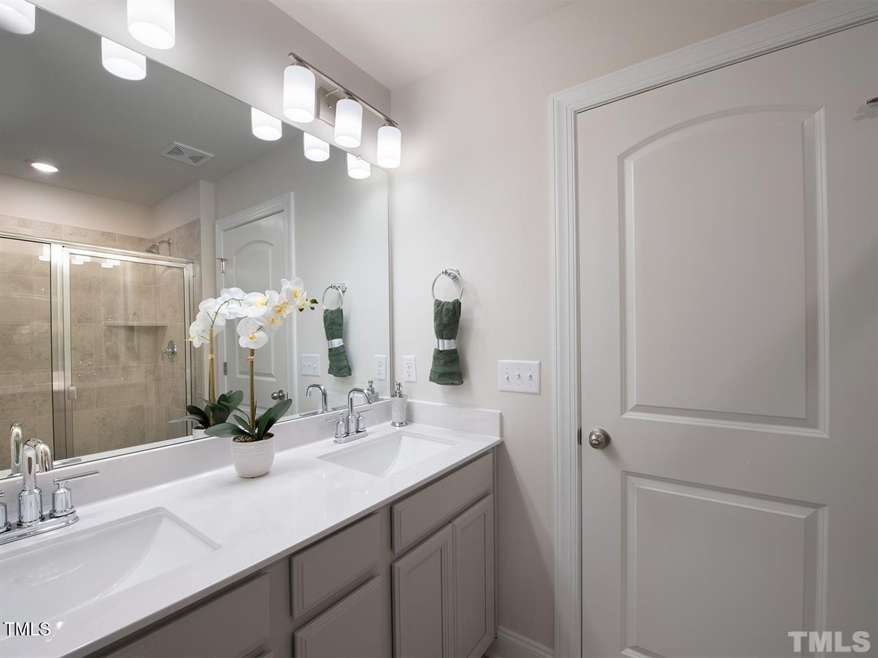 912 Field Ivy Drive Fuquay-Varina, NC 27526 - Photo 15 of 27 a bathroom with a sink a light fixture and a mirror