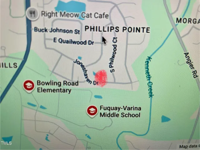 a kitchen with kitchen island a dining table chairs and a refrigerator