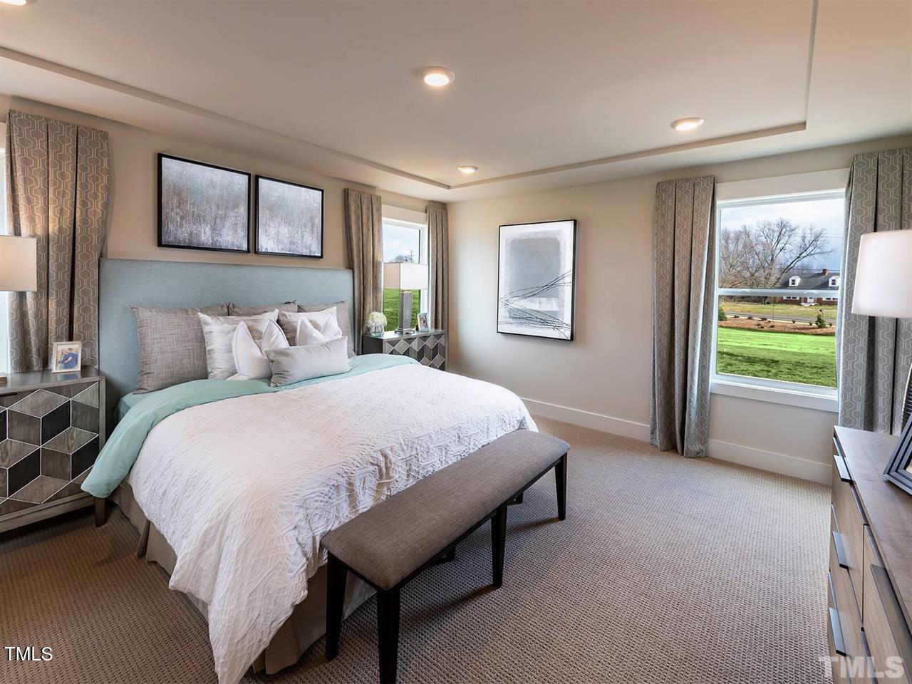 912 Field Ivy Drive Fuquay-Varina, NC 27526 - Photo 24 of 27 a spacious bedroom with a bed and a large window