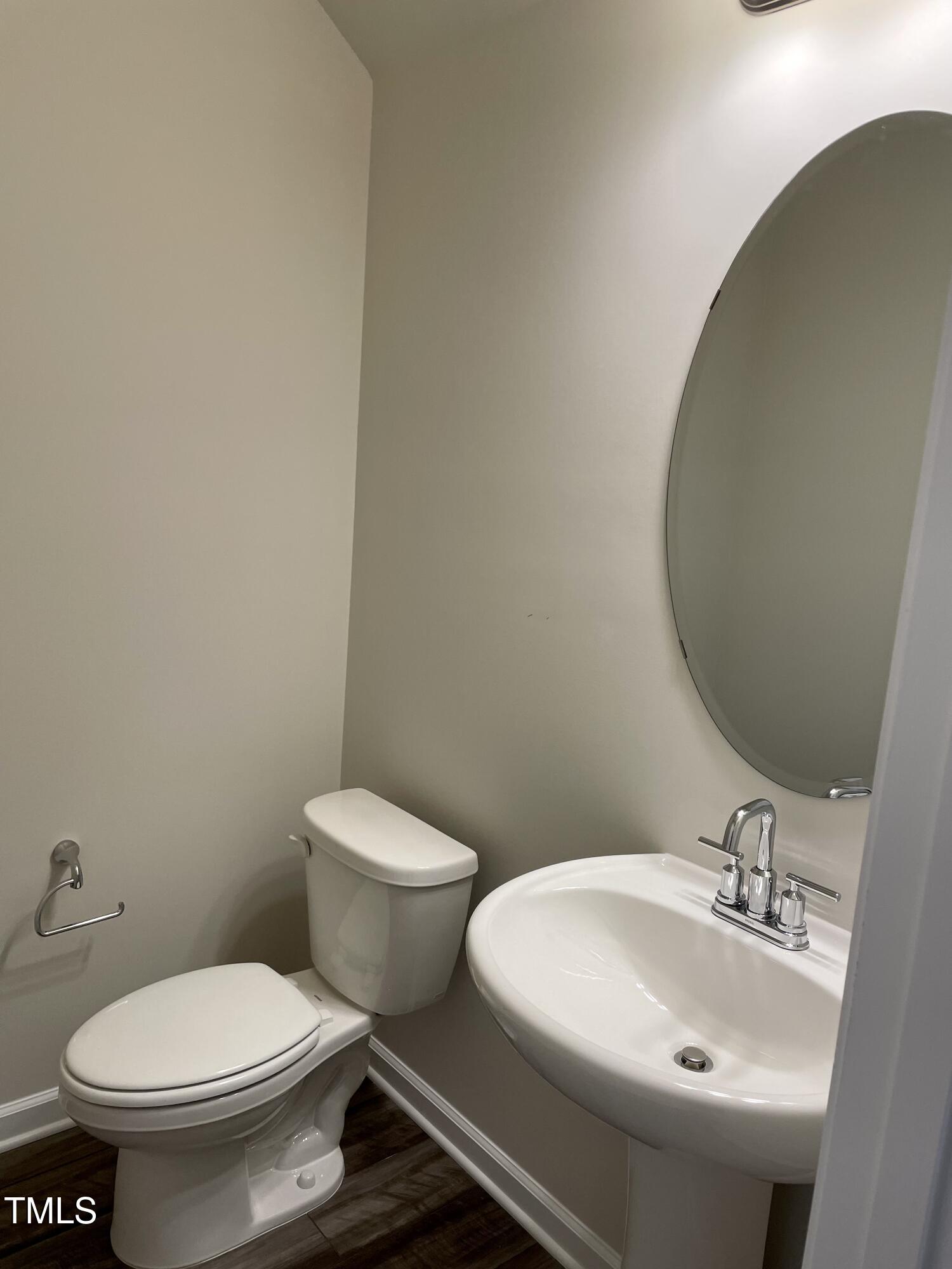 912 Field Ivy Drive Fuquay-Varina, NC 27526 - Photo 7 of 27 a white toilet sitting next to a bathroom sink
