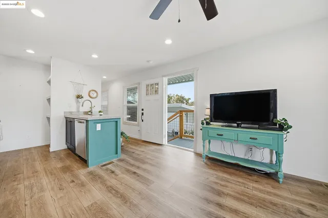 a kitchen with stainless steel appliances granite countertop a refrigerator a sink and a stove