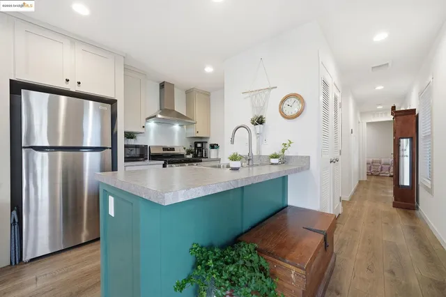a kitchen with stainless steel appliances granite countertop a stove and a sink with cabinets