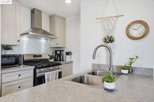 a kitchen with a refrigerator and a stove