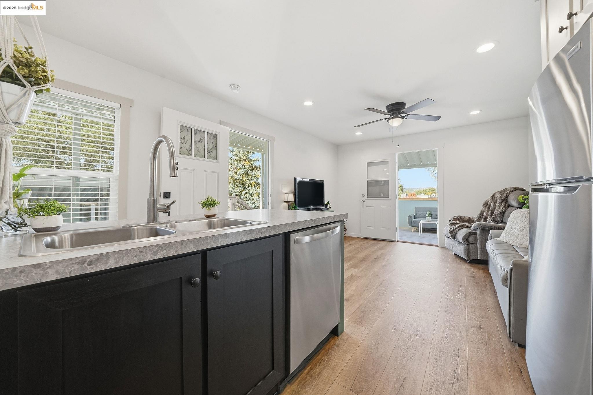 150 Clinton Road Jackson, CA 95642 - Photo 43 of 44 Kitchen featuring stainless steel appliances, open floor plan, light wood-style floors, light countertops, and recessed lighting